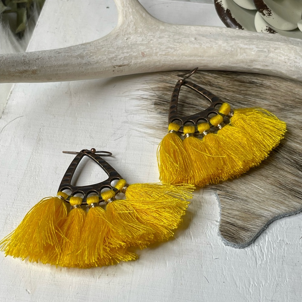 Sunny yellow tassels tied on a beautiful bronze earring set
